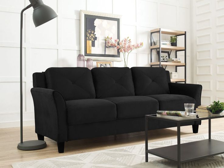 a living room with a black couch and coffee table