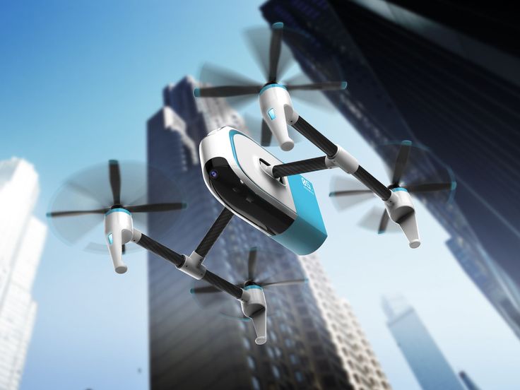 a small white and blue flying device in the air with city buildings in the background