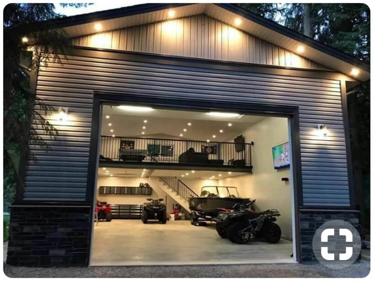 an open garage door with lights on the side and stairs leading up to the second floor