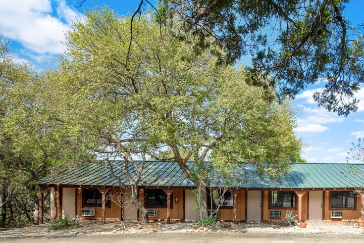 a small building with trees in front of it