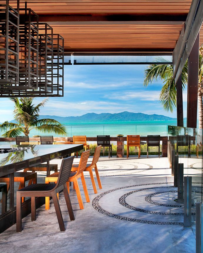 an outdoor dining area overlooking the ocean