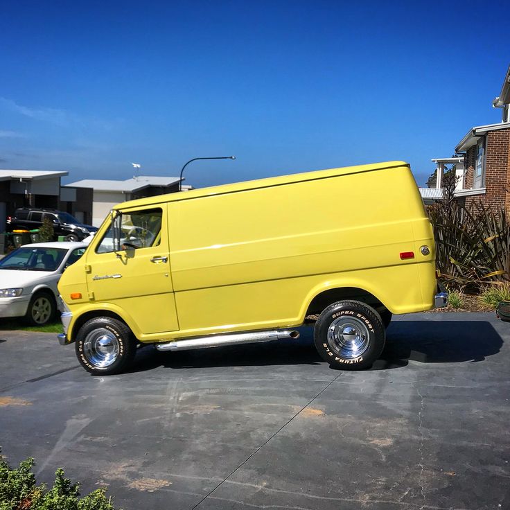 a yellow van parked in a parking lot