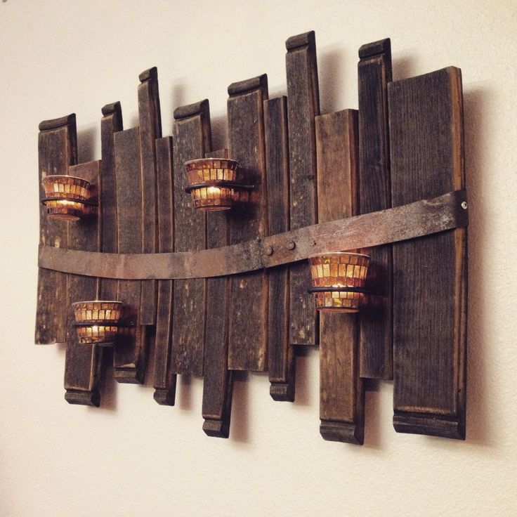 a wooden wall mounted with three lights on it