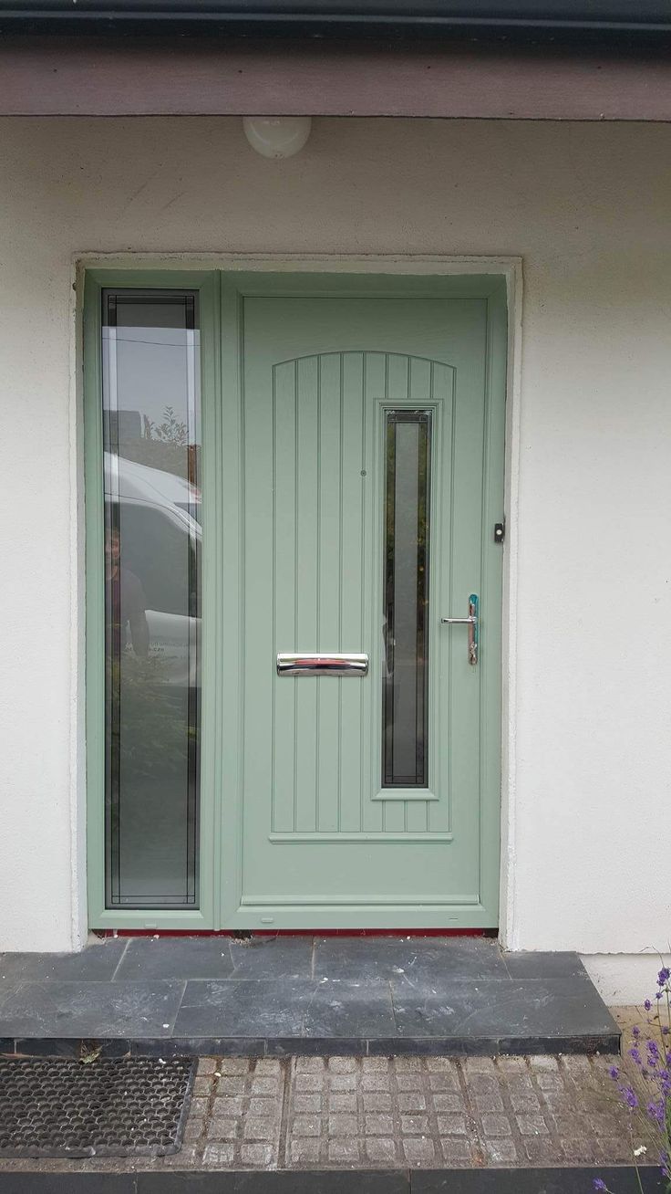 a green front door on a white house