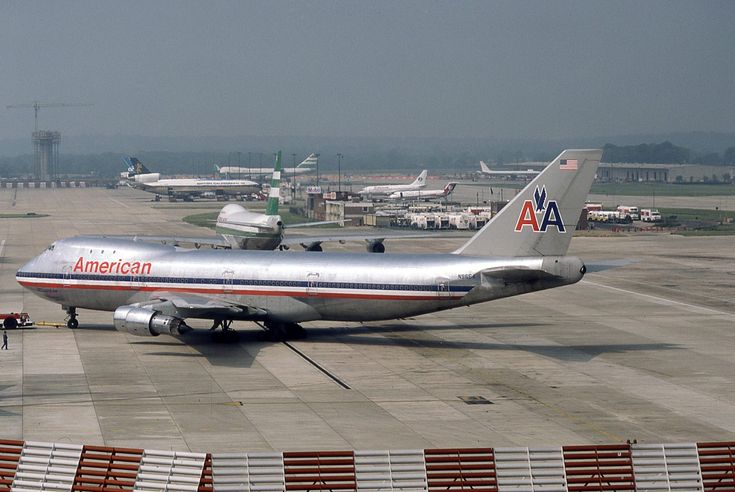 an american airlines plane is parked on the runway