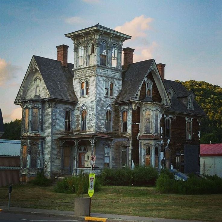 an old, run down house sits in the middle of a field