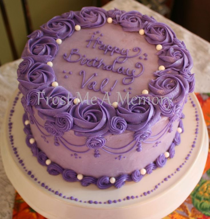 a birthday cake with purple frosting and roses