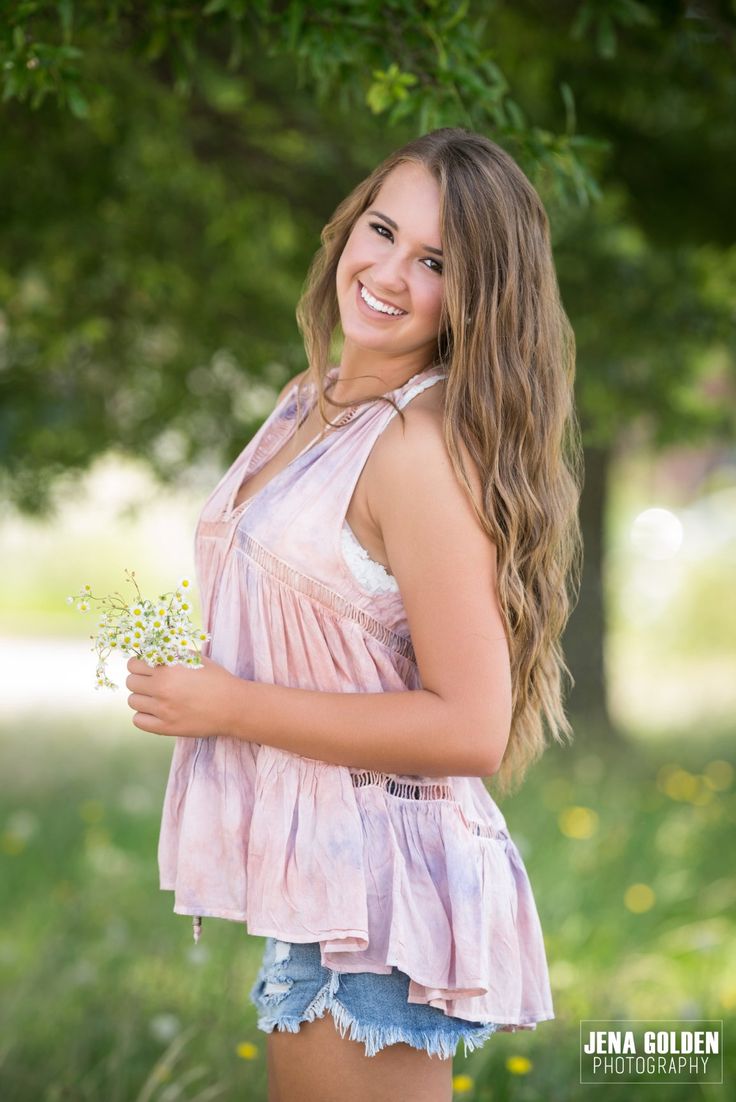 a beautiful young woman holding a bouquet of flowers