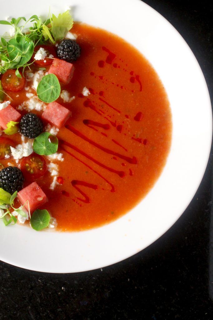 a white plate topped with food and garnished in sauce on top of a table