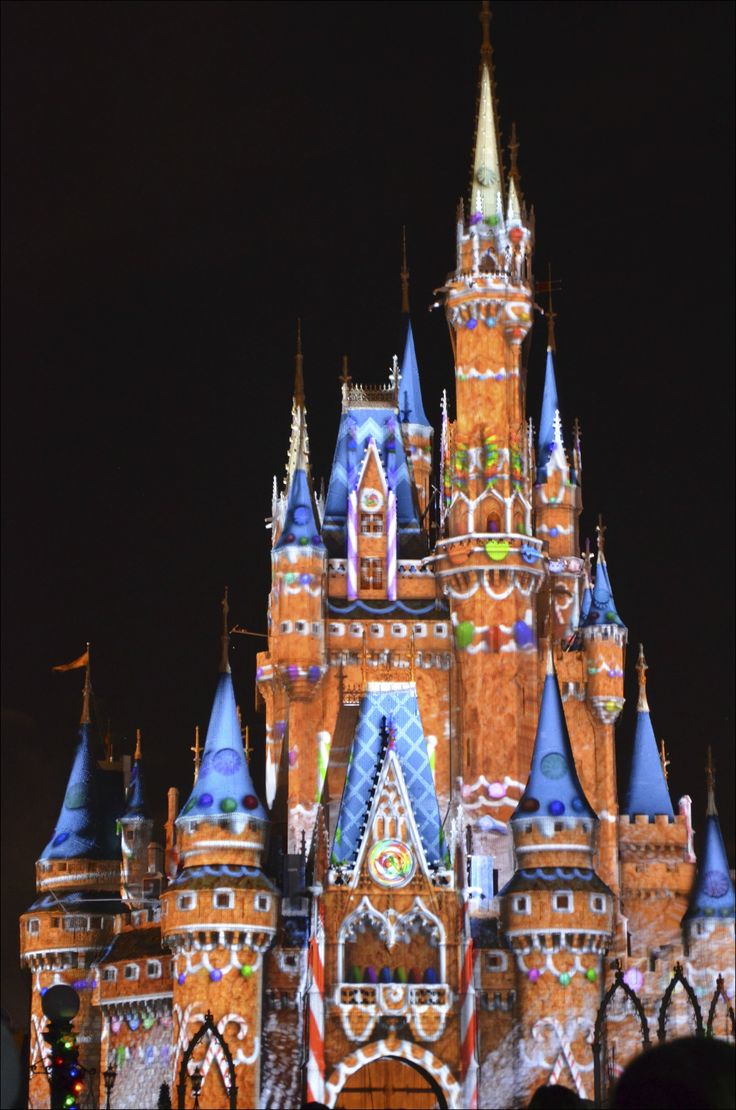 the castle is lit up at night with lights