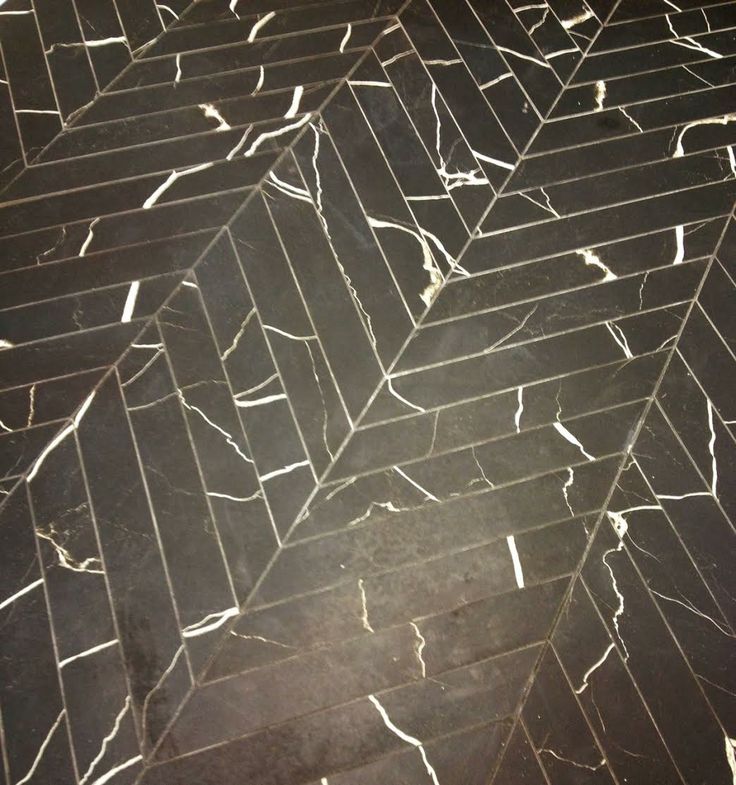 a black and white marble floor with lines drawn on it