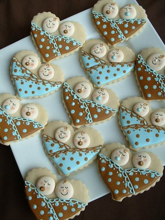 decorated cookies arranged in the shape of hearts and teddy bears on a white platter