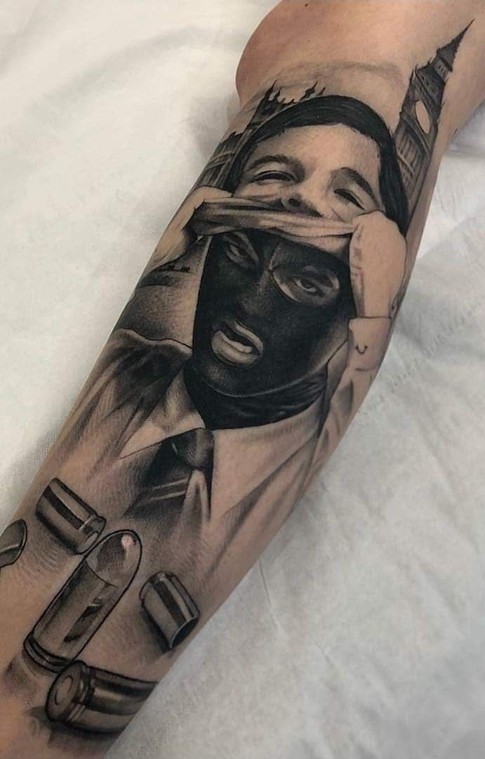 a man's leg with a black and white tattoo on it, which has an image of a person holding a trumpet