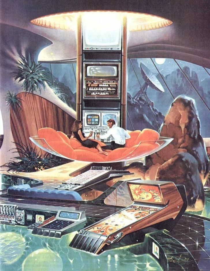 a man sitting on top of a red couch in front of a tv set and other electronic devices