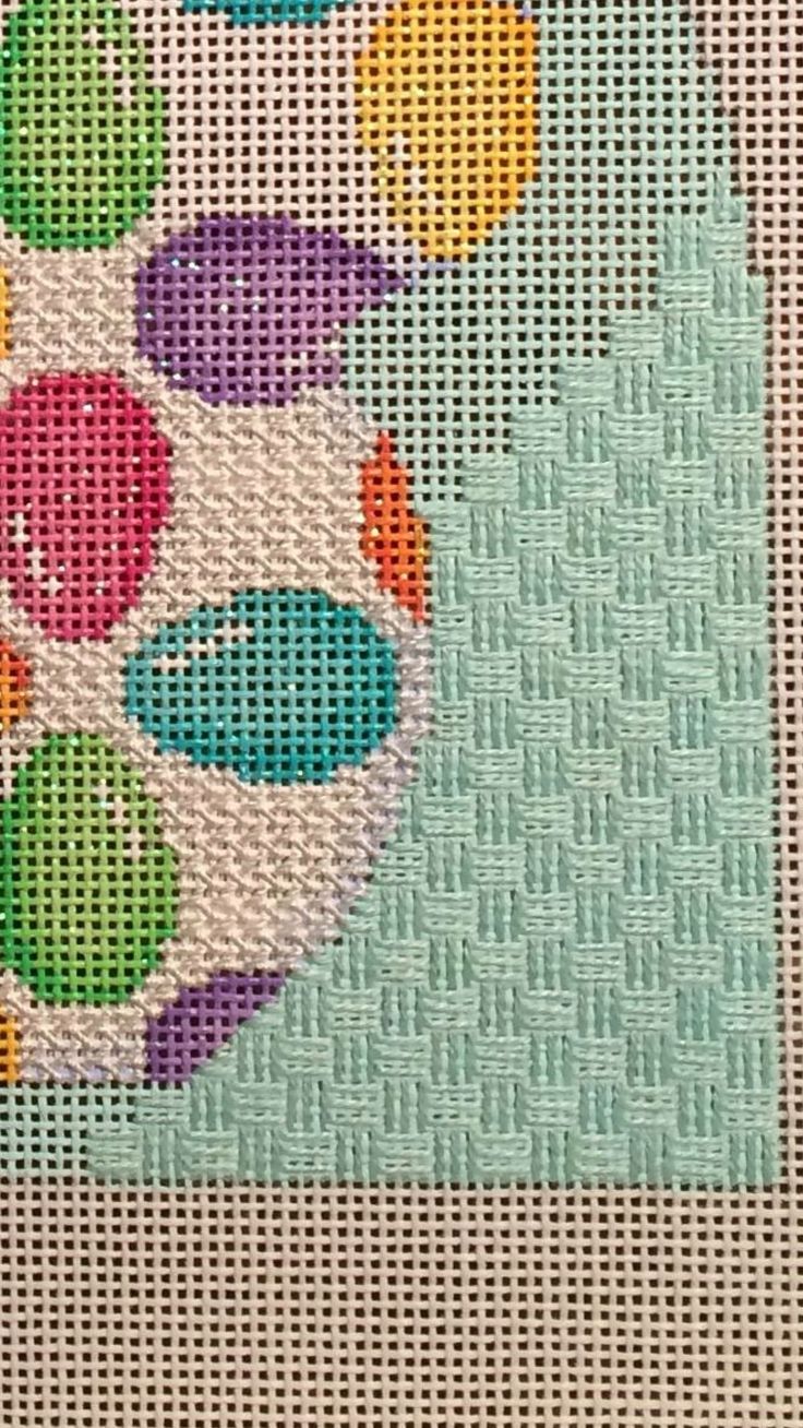 a cross stitch pattern with different colored balls on it