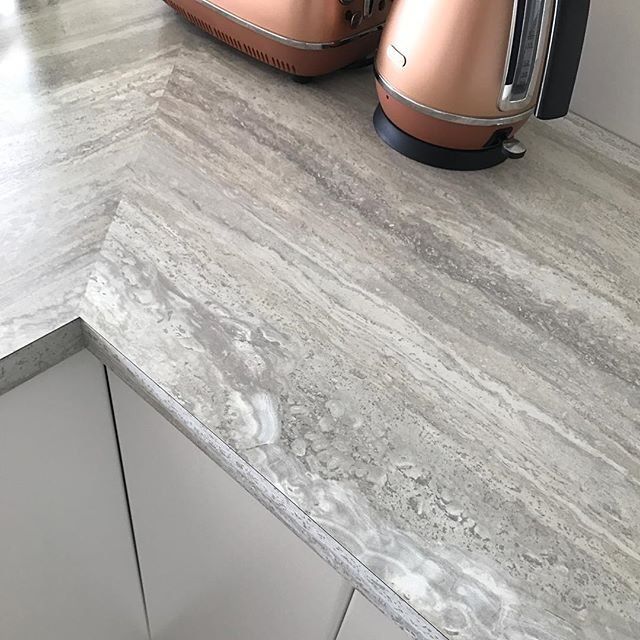 a toaster sitting on top of a counter next to a coffee pot and kettle