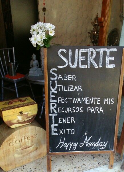 there is a sign that says suerte and other things in front of it