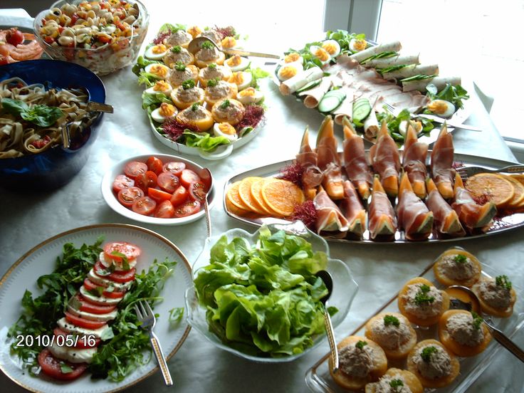 a table full of food including salads and appetizers