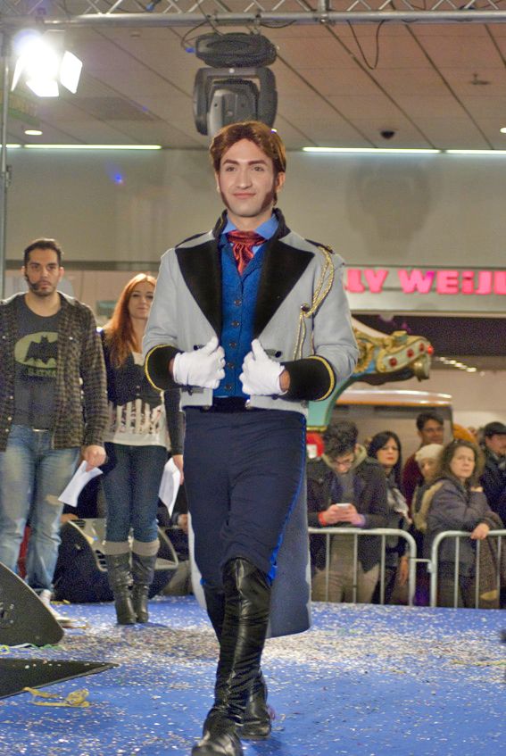 a man is walking down the runway at a fashion show