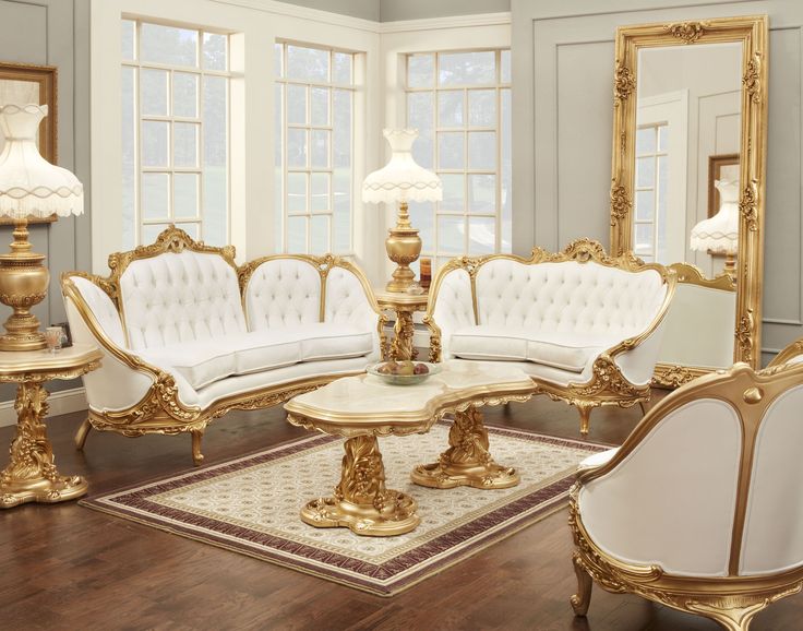 a living room filled with gold furniture and mirrors