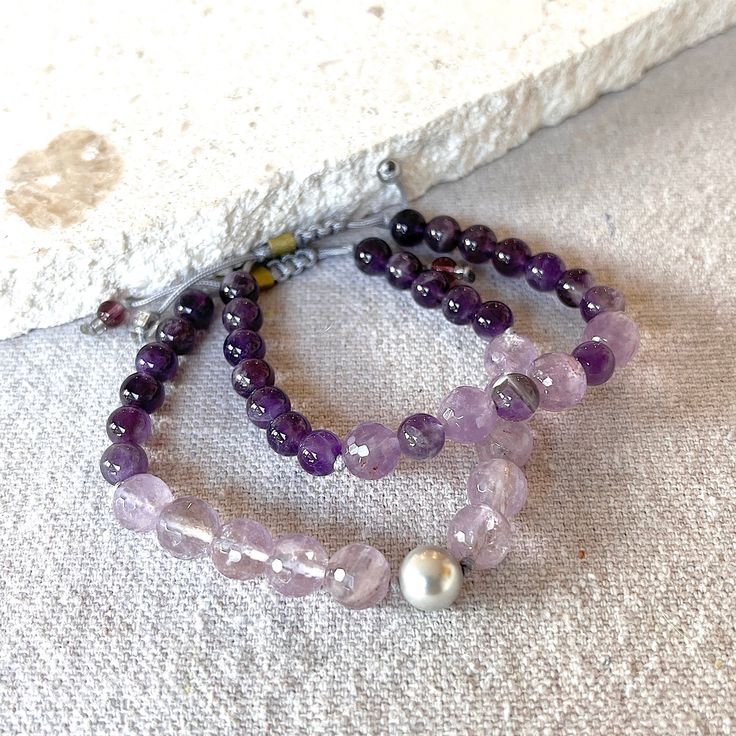 Indulge in the luxurious Crown Shambala Bracelet, adorned with Lavender Amethyst and a silver South Sea Shell pearl. Enhance your well-being by wearing one or stacking multiple bracelets. Experience the regal beauty of this must-have piece! Bracelet Details: South Sea Shell Pearl, Lavender Amethyst, Amethyst, Silver Cord Handmade in the USA Shambala Bracelet, Multiple Bracelets, Lavender Amethyst, South Seas, Sea Shell, Well Being, Sea Shells, Shells, Lavender