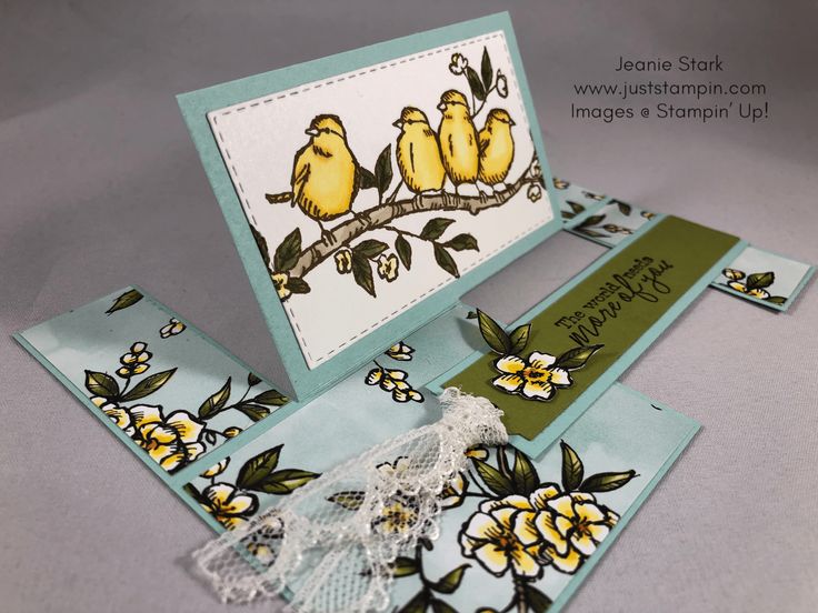 a card with two yellow birds sitting on a tree branch, and some doily