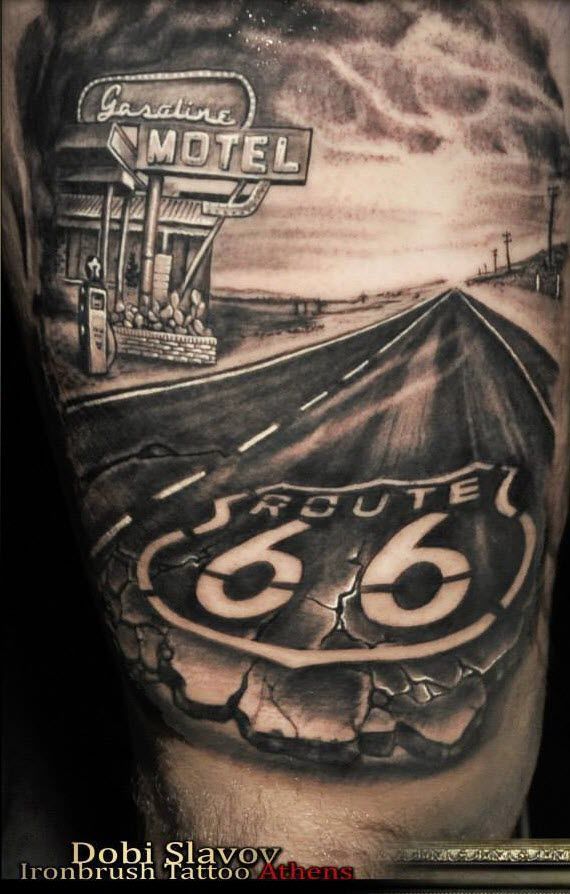 the back of a man's arm with an old route 66 sign on it