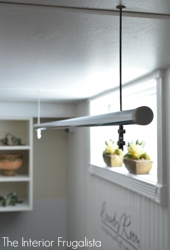 the light fixture is hanging from the ceiling in the kitchen, next to two flower pots