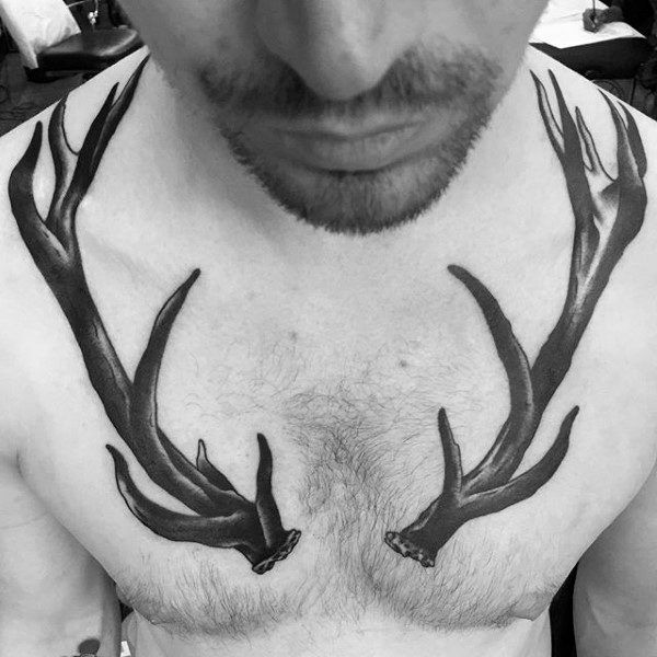 a man with some deer antlers on his chest