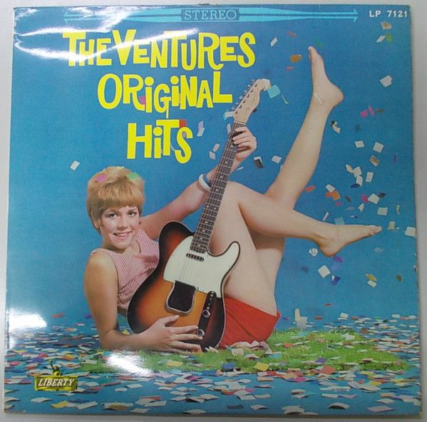 an album cover with a woman laying on the ground holding a guitar and confetti