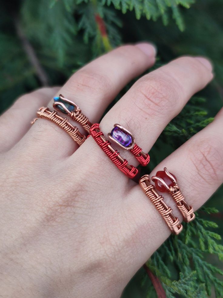 This ring combo is made of 3 handmade wire-wrapped copper rings: - Red agate ring - Purple glass red ring - Abalone shell ring These rings are all adjustable and made from 2 types of copper, raw and varnished. -Tarnish-proof and won't leave green marks on your finger. -To clean, dip the ring for 5 seconds in a mixture of vinegar and salt, then rinse with water and dry well. -suggested not to swim or shower with the rings on regardless. *These rings are sold as a set, you will get all 3 if purchased. Check these listings out: Red agate necklace: https://www.etsy.com/listing/1474737144 Amethyst necklace: https://www.etsy.com/listing/1387983713 Other rings set: https://www.etsy.com/listing/1661783772 Have any questions? Be sure to message me :) Check out my Instagram profile: @bronzaii.jewelr Handmade Adjustable Crystal Promise Ring, Handmade Adjustable Stackable Rings As Gift, Handmade Crystal Metal Ring As Gift, Unique Handmade Adjustable Stackable Rings, Handmade Metal Crystal Ring Gift, Handmade Metal Stackable Rings For Jewelry Making, Adjustable Hand Wrapped Stackable Rings For Gifts, Handmade Metal Crystal Ring As Gift, Adjustable Wire Wrapped Stackable Rings As Gift