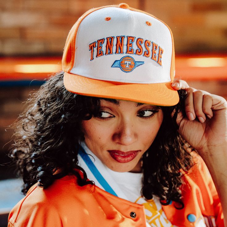 The Tennessee Lady Vols made this powder blue famous during their meteoric rise, but the logo on this specific hat dates back to the 1970s, when 22 year-old graduate assistant Pat Summitt was thrust into the spotlight as the Lady Vols' head coach. While Summitt was building the women's team, Ernie Grunfeld and Bernard King, aka the “Ernie and Bernie Show,” led UT men's basketball to a 61-20 record over three years and helped the Vols win the 1977 SEC title. Brought to you in partnership with Col Collegiate Snapback Fitted Hat For Fans, Collegiate Snapback Hats For College, Collegiate Fan Merchandise Snapback Hats, Retro Snapback Hat With Flat Brim For Fan Gear, Retro Flat Brim Snapback Hat For Fan Gear, Collegiate Snapback Hat With Flat Brim For Fans, Throwback Snapback Trucker Hat For Sports Events, Collegiate Style Snapback Hat With Flat Brim For Fans, Retro Trucker Hat For Sports Events With Flat Brim