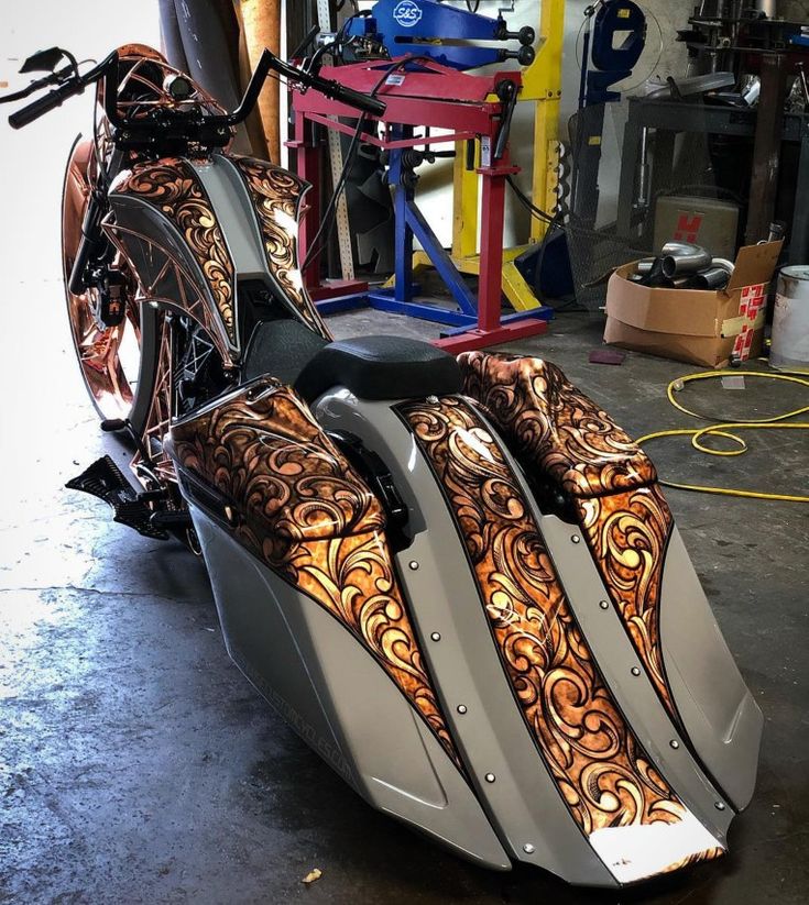 an intricately designed motorcycle parked in a garage