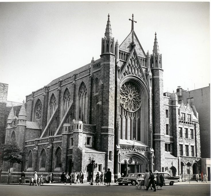 an old black and white photo of a church with people standing in front of it