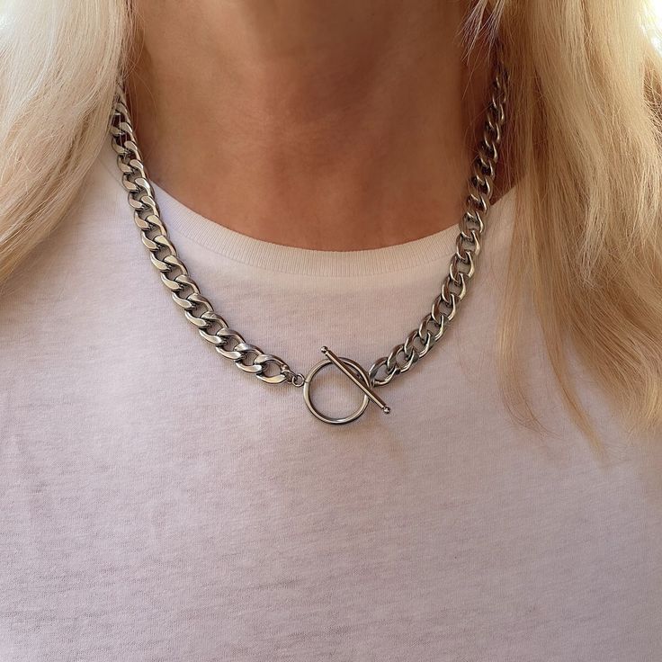 "This unisex silver necklace is about to be your everyday go-to for layering or as a solo statement piece -- it's all up to you. A stainless steel curb chain connected with a t-bar toggle, the perfect statement chain choker necklace that will have everyone talking. Details * WATERPROOF * Material: silver plated stainless steel chain 13mm. * Chain Style: Curb * Chain thickness: 3mm * Different Chain lengths (from 16\" to 20\" inches long including the clasp). Choose the length from the dropdown m Luxury Chain Link Toggle Necklace For Formal Events, Curb Chain Necklace For Gifts, Cheap Sterling Silver Curb Chain Necklace, Everyday Metal Toggle Necklace Choker, Metal Choker Toggle Necklace For Everyday, Everyday Metal Toggle Choker Necklace, Everyday Silver Toggle Necklace With Adjustable Chain, Silver Toggle Choker Necklace With Lobster Clasp, Silver Toggle Chain Choker Necklace