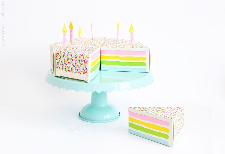 there is a cake with candles on it and two pieces missing from the cake are sitting next to each other