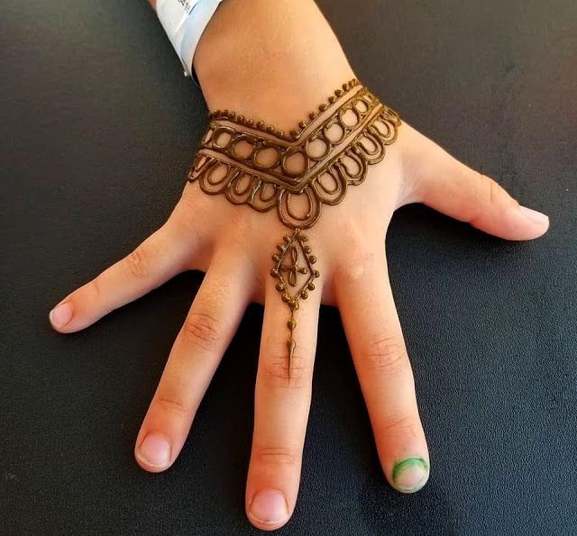 a woman's hand with henna on it