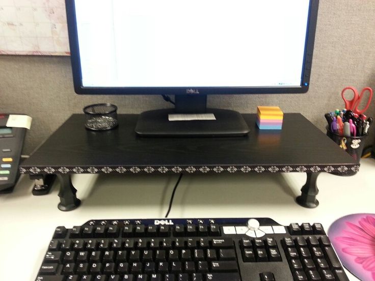 a computer keyboard sitting on top of a desk next to a monitor and mouse pad