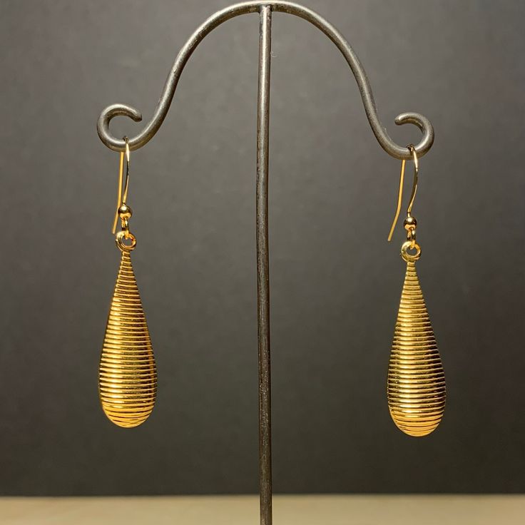 Here is a pair of assertively mid century modern, teardrop shaped dangle earrings.  These were actually made in the early seventies. They are good quality, new (unused) vintage items, made of gold plated brass. 11mm wide x 50mm high (with earwire) BOX10 IMPORTANT: please note that I offer different earwires as seen in second picture, and the price of the earrings vary depending on the chosen earwires.  It goes as follows: A: gold plated base metal french wires with ball (rubber stoppers included Pierced Metal Drop Earrings, Pierced Drop Metal Earrings, Metal Teardrop Drop Earrings, Metal Teardrop Pendant Earrings, Metal Teardrop Pendant Earrings With Ear Wire, Handmade Teardrop Hoop Earrings For Formal Occasions, Retro Dangle Earrings For Formal Occasions, Gold Teardrop Pendant Earrings With Ear Wire, Modern Teardrop Pendant Earrings With Ear Wire