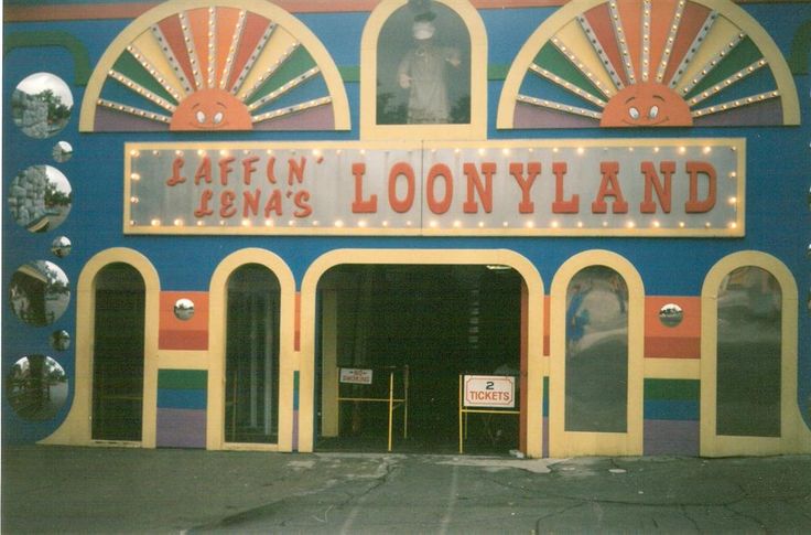 an old photo of the front entrance to loonyland, with lights on