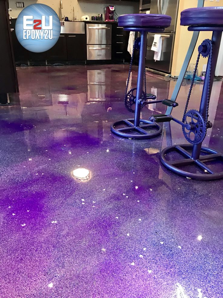 two purple stools sitting on top of a shiny floor