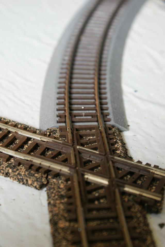 a train track that has been cut into two pieces and is laying on the ground