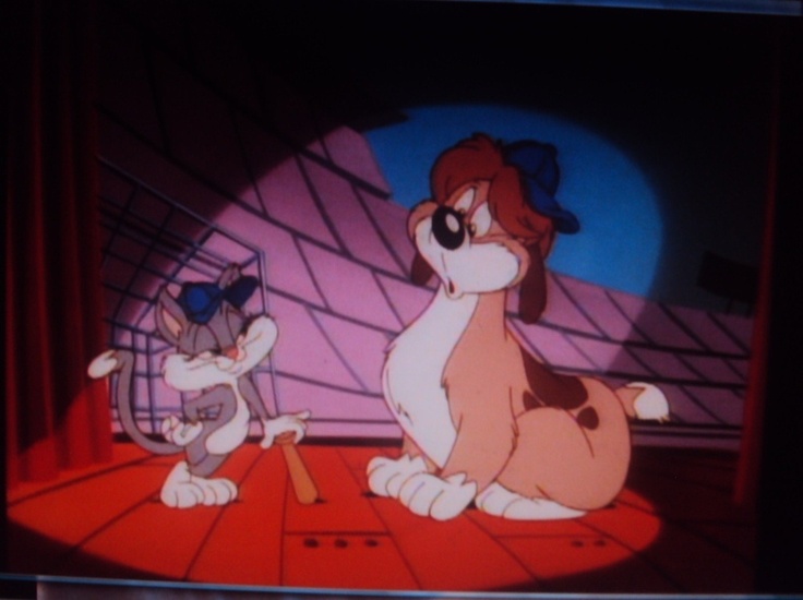 the cartoon dog and cat are playing together in front of an empty television screen,