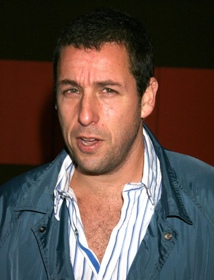 a man wearing a blue jacket and striped shirt