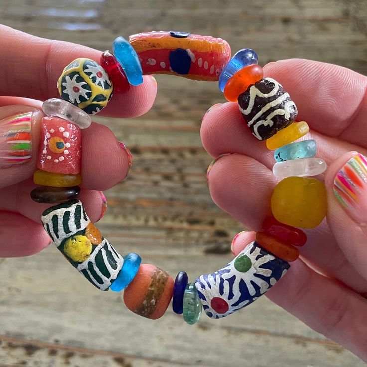 "Handmade African Glass Beaded Bracelets, Beautiful, Colorful 7\" African Trade Bead Bracelet This is made from African Trade Beads, none are perfect or exactly the same.  Trade beads are beads that were used as a medium of barter within and amongst communities. They are considered to be one of the earliest forms of trade between members of the human race. Size: All bracelets are about 7\" Beads: Huge Range please see all pictures  *If you don't see what you want or need a different size, message me! I am happy to custom make a bracelet for you!  Note: colors may differ depending on your monitor www.BettysGlassBeads.Etsy.com" Spiritual Stretch Bracelet With Large Beads For Beach, Colorful Oval Beads Bracelets For Beach, Colorful Oval Beads Bracelet For Beach, Beach Beaded Bracelets With Large Oval Beads, Colorful Oval Beaded Bracelets For Beach, Bohemian Multicolor Beaded Bracelets With Heart Beads, Colorful Hand-strung Spiritual Beaded Bracelets, Bohemian Beaded Bracelets With Heart Beads For Crafting, Spiritual Beaded Bracelets With Large Beads For Beach