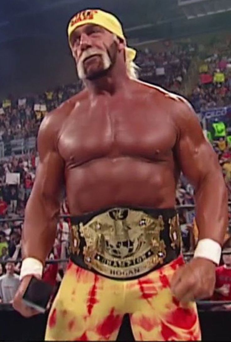 an image of a wrestler in the middle of a wrestling ring with his hands on his hips