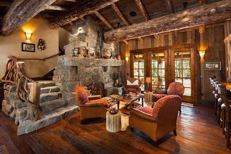 a living room filled with furniture and a stone fireplace