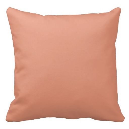 a peach colored pillow on a white background