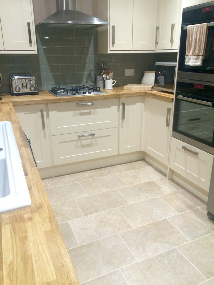 a kitchen with an oven, sink and dishwasher on the counter top in it