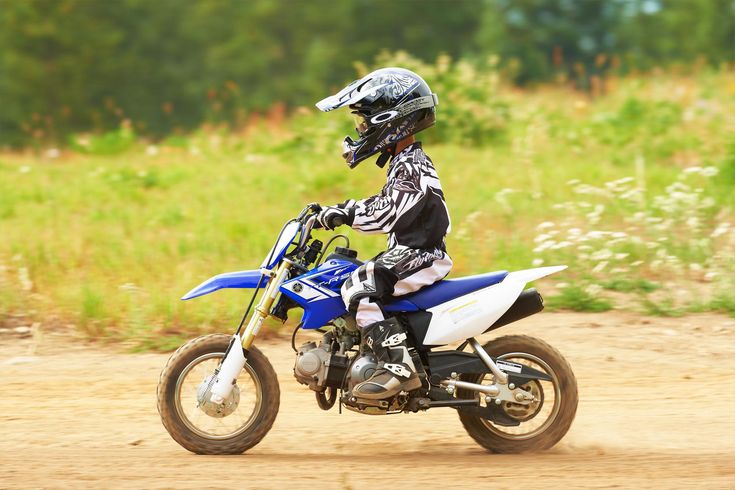 a person riding a dirt bike on a dirt road